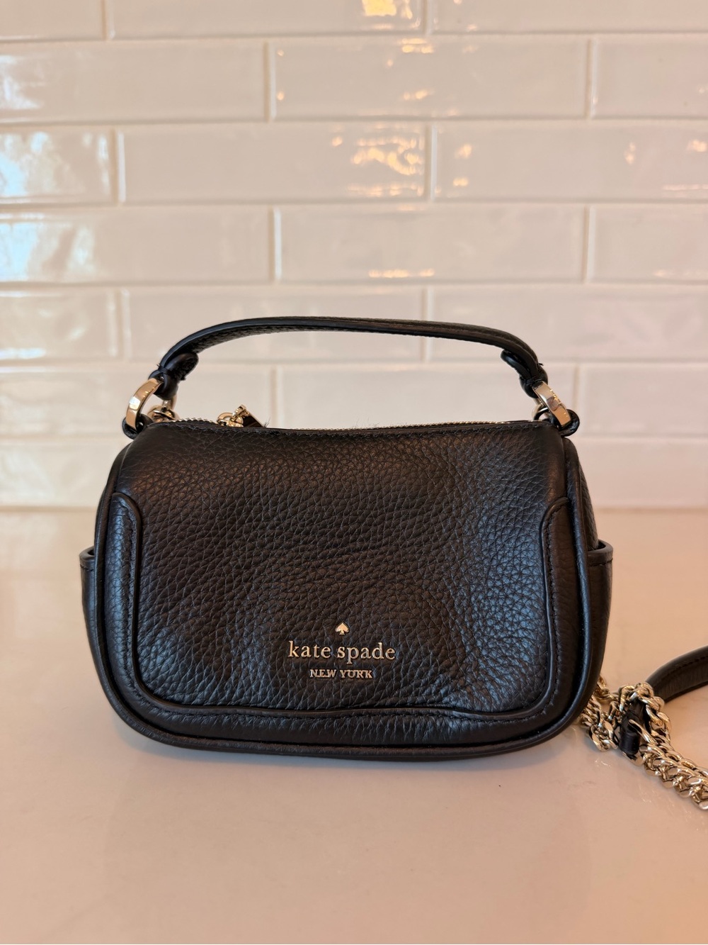 Kate Spade Smoosh Micro Crossbody made from pebbled leather